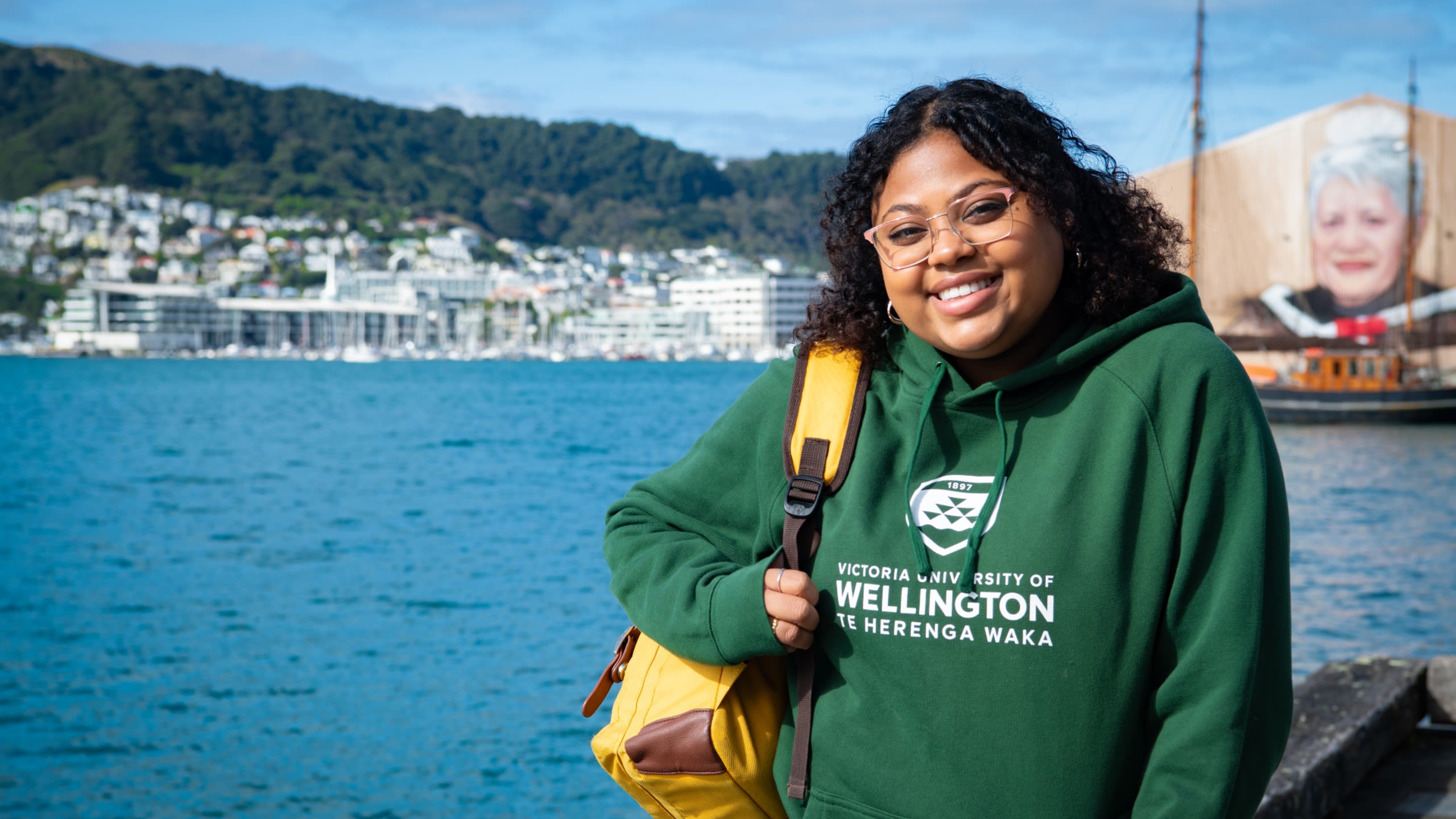 Yasmeen standing by the water at Wellington waterfront. 