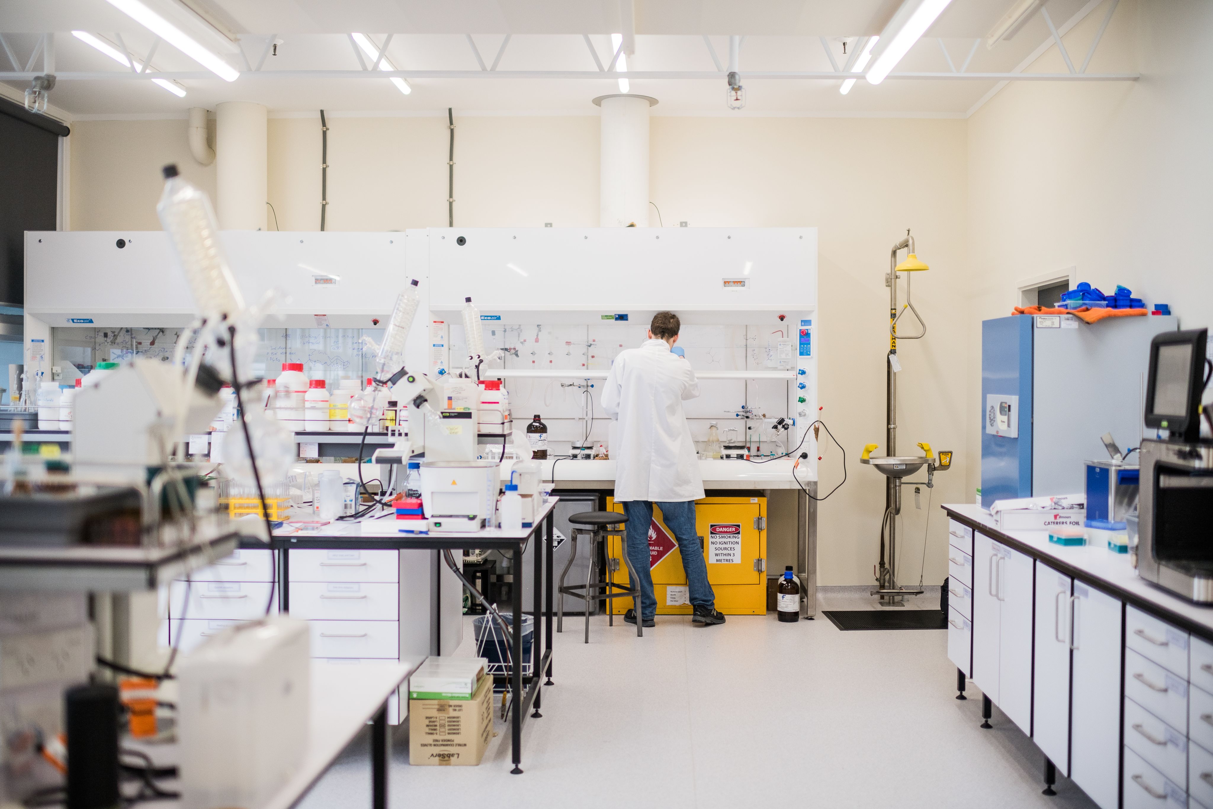 Person in white lad coat working in a lab