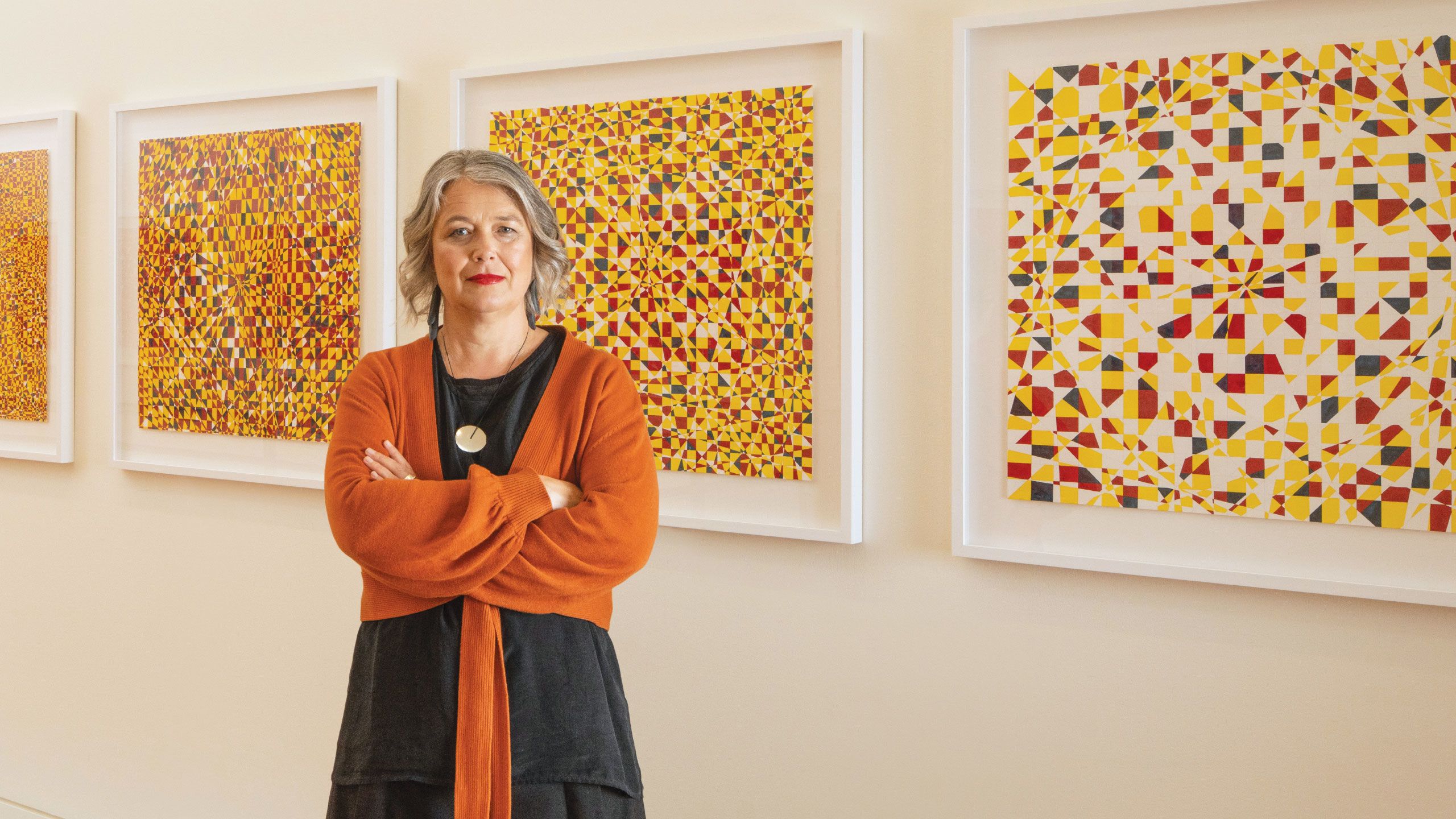 Su Ballard in front of artwork at the Adam Art Gallery, Wellington