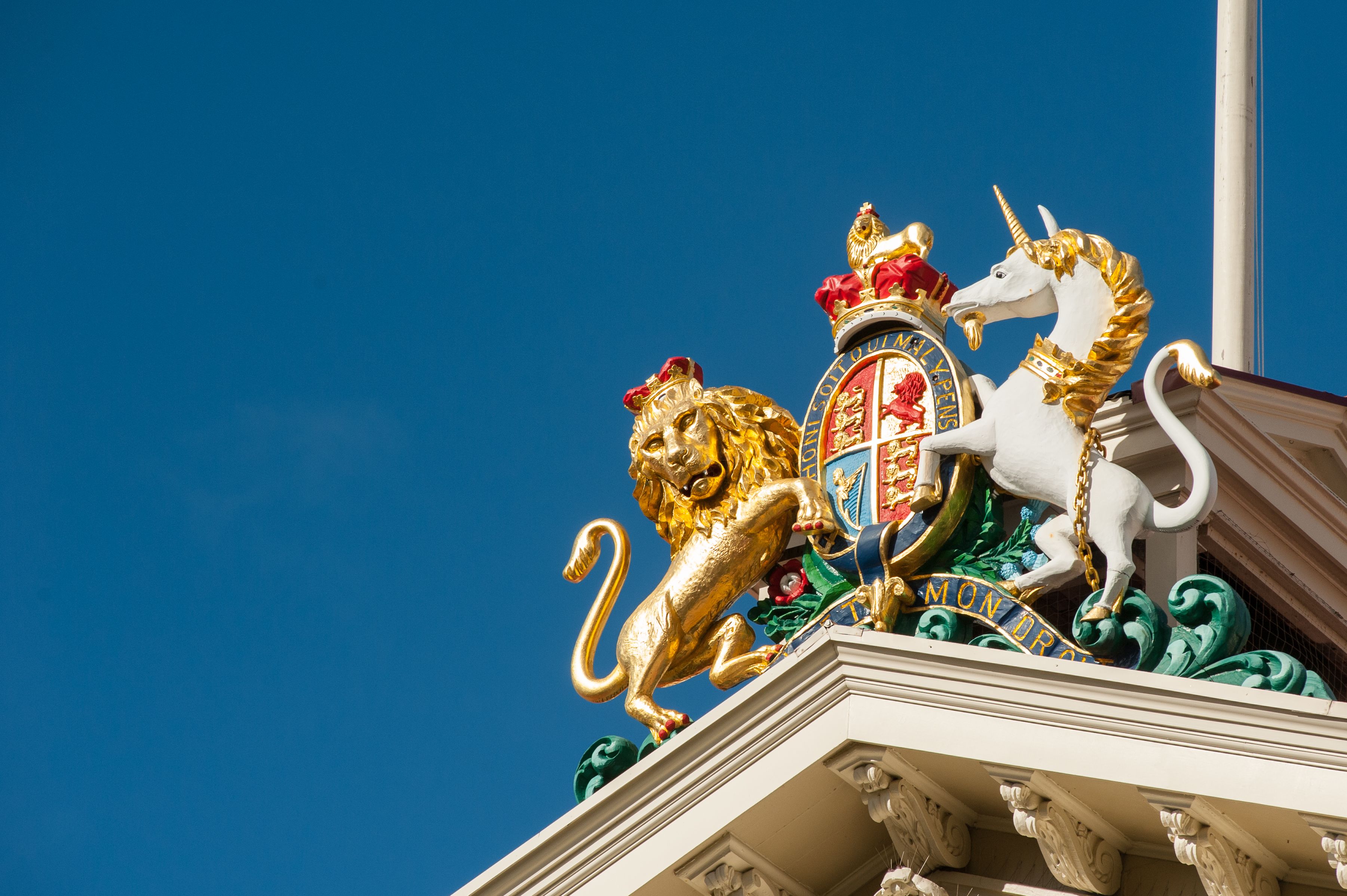 The Lion and Unicorn royal coat of arms on top of a building.