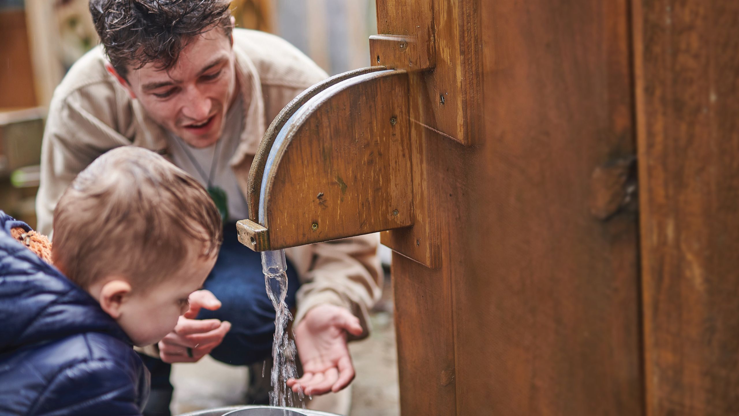 Josh Allen showing a small child a water tap