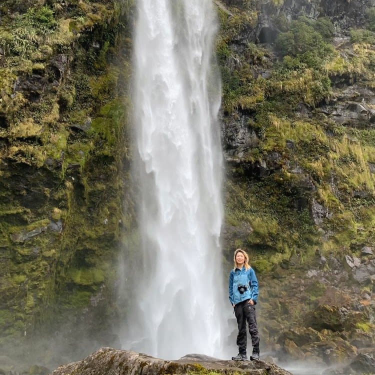Ripley standing in front of a waterfall.