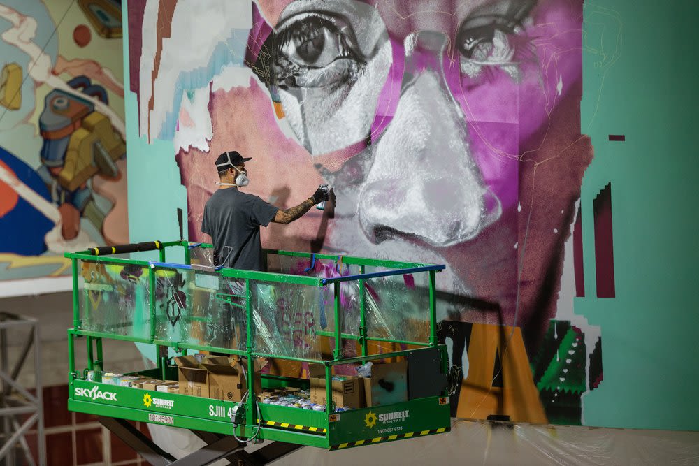 Elliot working on a mural for Oasis in Prim, Nevada. Photo credit:Luke Shirlaw