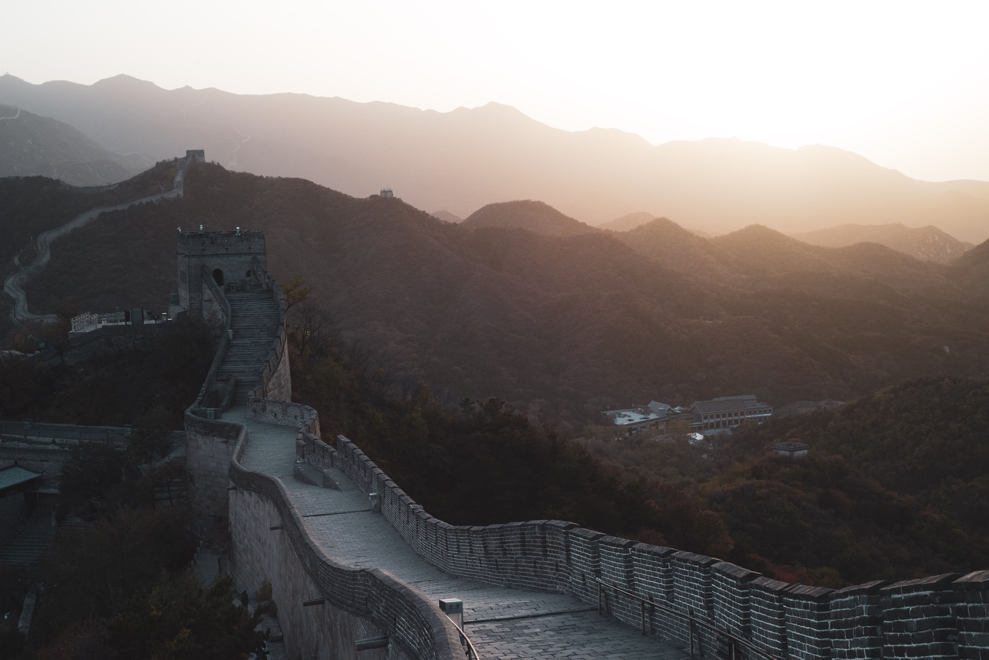 The great wall of china with a picturesque landscape of green rolling hills in the background